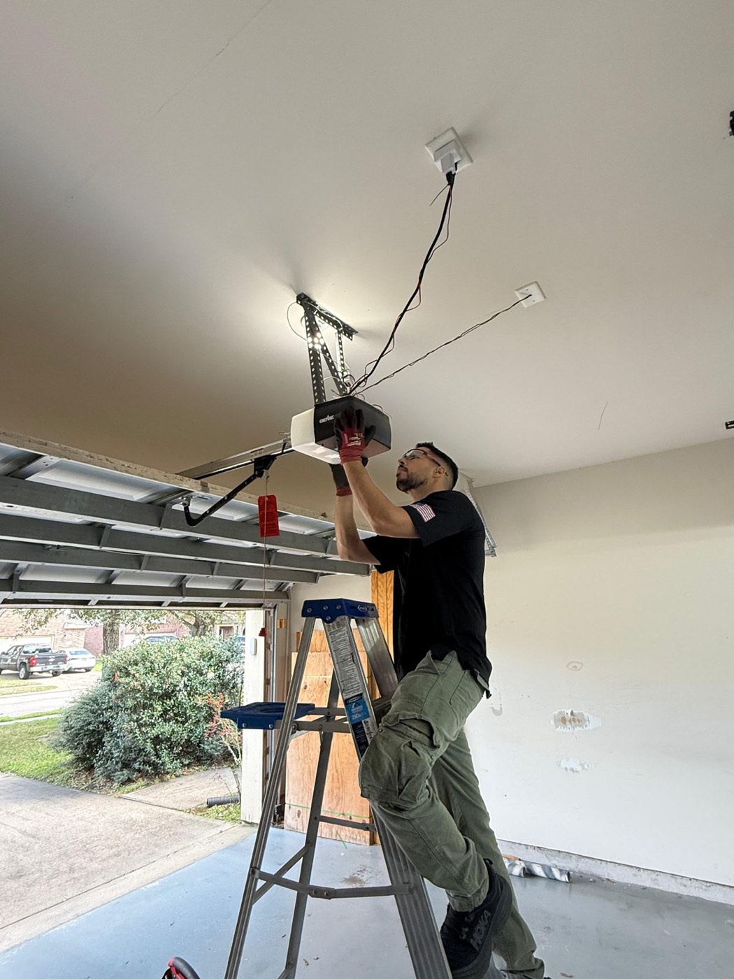 Technician installing a garage door opener