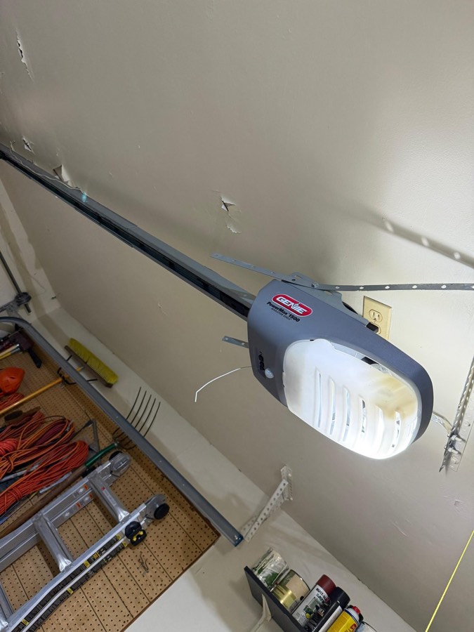 Garage door opener unit mounted to the ceiling